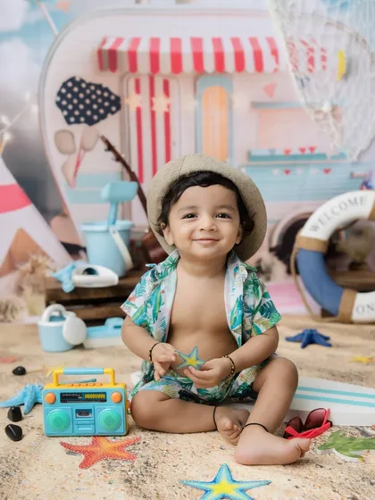 A sweet moment holding a starfish prop during his beach-themed session.
