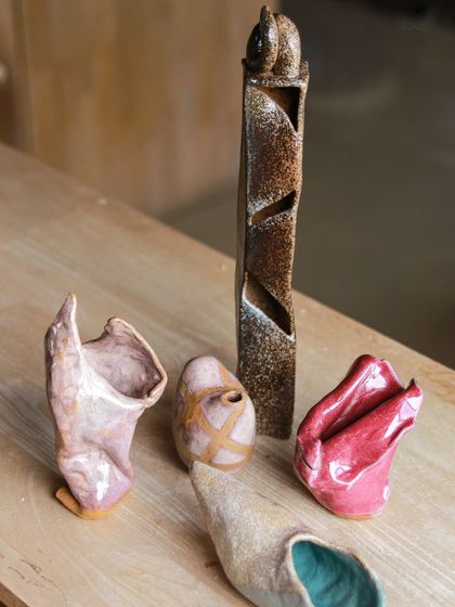 A stunning group of sculptural vases and forms, demonstrating the students' creativity in altering and assembling wheel thrown pieces.