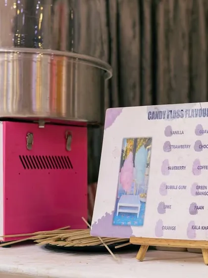 It all starts here. Our professional cotton candy machine is set up with a clear menu displaying our 12 exotic, organic, and colorless flavor options for guests to choose from.