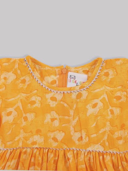 A close-up of the delicate stitching around the neckline of one of our floral dresses. I believe true fashion isn't just what you wear, but how it makes you feel.