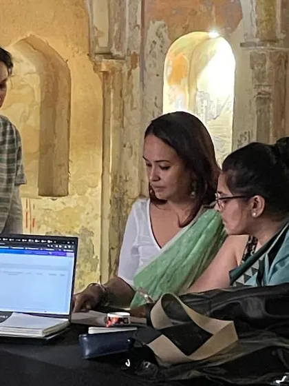 During a workshop on International Museum Day, I work with students to explore the role of museums for local communities. Here, we are reviewing research on a laptop within the atmospheric setting of a heritage building.