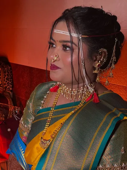 A profile shot of the bride, showcasing her elegant hairstyle and the dramatic lighting.