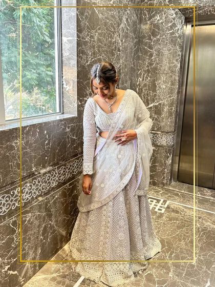A quiet, elegant moment captured of a client in a white chikankari lehenga.