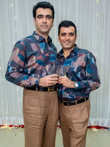 Two clients looking sharp in matching custom-made shirts with a modern abstract print. This shows how I can create coordinated looks for friends or family, tailored to each individual's fit.
