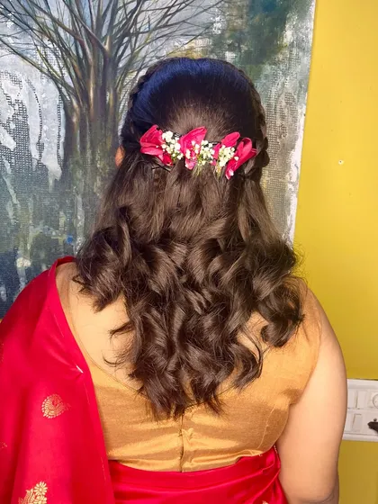 The back view of this half-up style, showing the line of fresh pink flowers that adds a festive touch.
