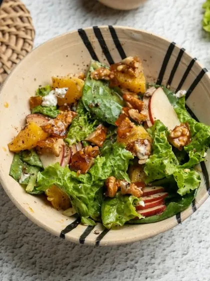 A fresh salad served in one of my hand-painted bowls. The black stripes add a modern, graphic touch to the earthy stoneware, creating a beautiful contrast with the vibrant food.