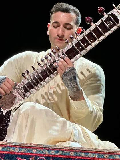 A close-up during a performance in London, showing the henna tattoos on my hands. These designs are an integral part of my performance identity.