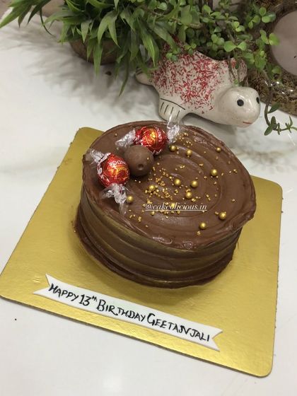 A cake for a true chocolate lover. This cake is made with pure Lindt chocolate ganache, created for a client's daughter who adores Lindt chocolate.