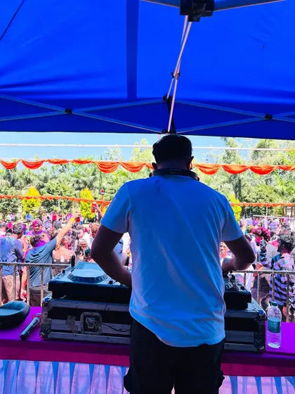 There's nothing like a daytime Holi festival. This is my view from the console, looking out at a massive, colorful crowd dancing under the sun. I love bringing high energy Bollywood and Punjabi bangers to these outdoor events.