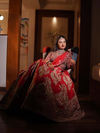 A seated portrait that showcases the grandeur of her lehenga and the flawless application of her makeup.