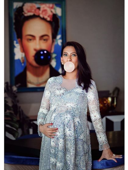 Ready to pop! This creative maternity portrait combines the client's personality with her favorite piece of art, showing how we can personalize a home session to be uniquely you.