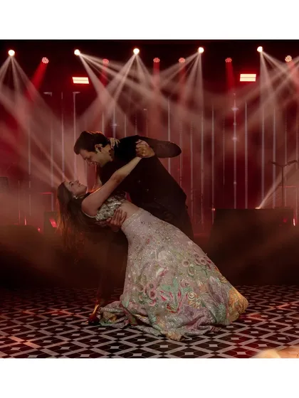Khushboo and Varddan share a dramatic dip during their first dance. The lighting, the smoke, and their perfect form make this a truly cinematic and romantic moment.