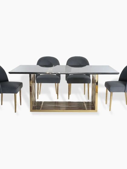 A full view of the six-seater dining set, showing the clean, rectangular lines of the table and the comfortable, modern design of the chairs. The gold PVD finish adds a touch of luxury.