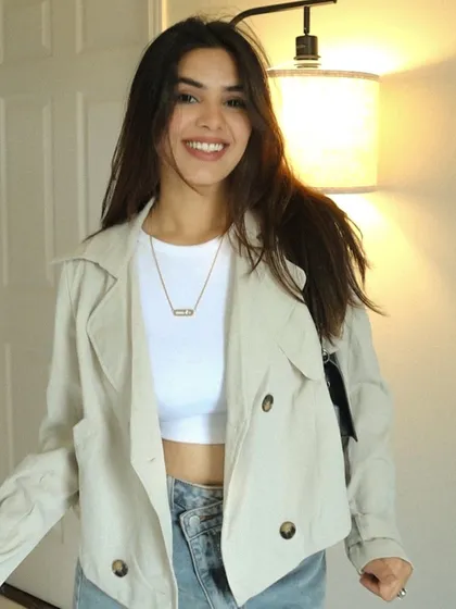 A happy, smiling indoor shot showing a casual and cute outfit.
