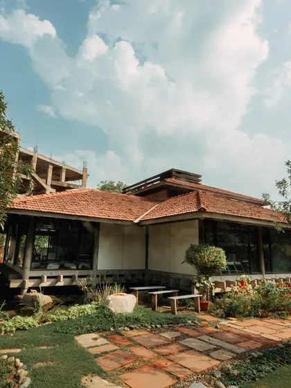 These images offer a tour of Yogakshema. From the serene pond with lotuses to the carefully arranged practice hall and the beautiful pathway decorated for an event, every corner of my center is designed to inspire peace and mindfulness.