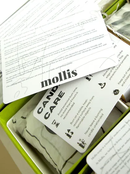 A look inside the elegant Rakhi gift box, showing the candle care cards and other thoughtful details.