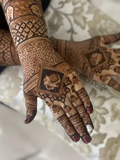 A close-up of a back-hand design featuring a prominent elephant in a diamond-shaped frame.