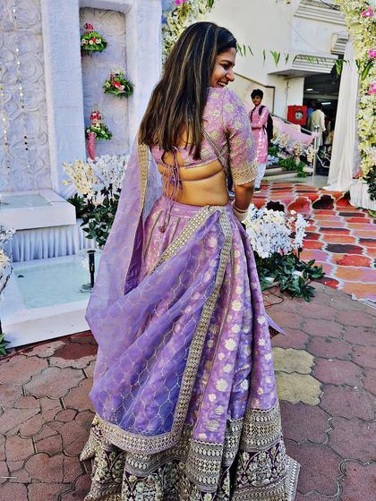 The back view of our lavender lehenga with traditional motifs. The tie-up backless blouse is a classic detail that adds a touch of allure.