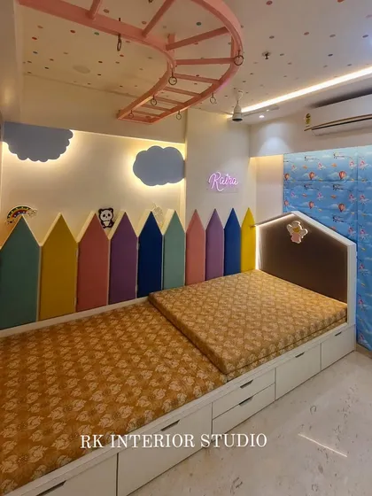 A child's room should be a place for imagination to grow. This kids' bedroom features a colorful pencil-themed headboard, custom beds with built-in storage drawers, and a playful, space-themed wall to create a fun and functional environment.