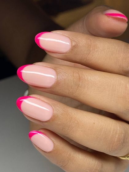 A vibrant and modern French manicure with hot pink tips. This design adds a fun and playful pop of color to the classic style.