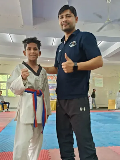 A moment of encouragement with a student after his match. Win or lose, the experience is what matters most.