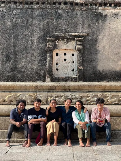 The talented young photographers from our Our Shared Cultural Heritage (OSCH) program, sitting together at the 1000-year-old Ramalingeshwara temple during a field trip.