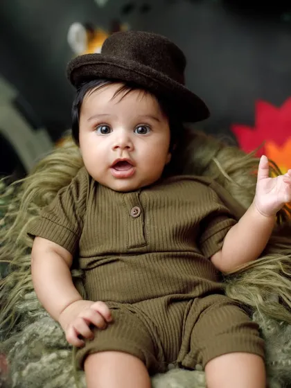 A look of wide-eyed wonder. This safari-themed portrait captures the curiosity of a baby exploring his new surroundings in the studio.