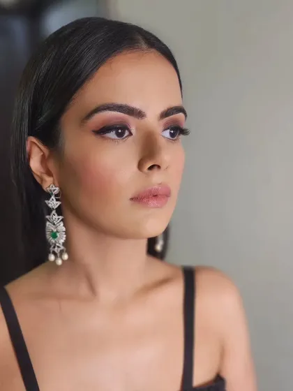 Beauty in black. This minimalist look features a classic winged eyeliner and soft, glowing skin, creating a timeless and sophisticated style for a night out.