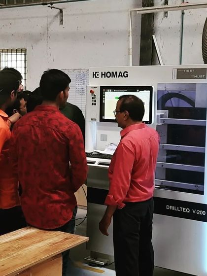 Students get an up-close look at a high-tech drilling machine during a factory visit, seeing the industrial application of the technology they learn in our workshop.