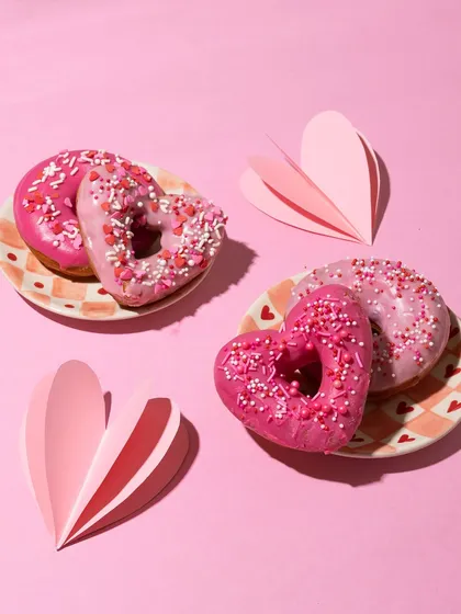 A pretty pink flat lay of my Valentine's Day donuts. The heart shape and sprinkles make them extra special for the month of love.