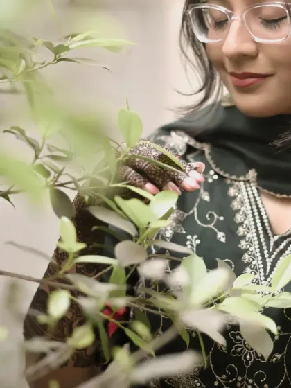 A soft and gentle portrait of the bride, admiring the leaves. This candid shot, taken during her Mehendi, has a quiet, reflective quality that I love.