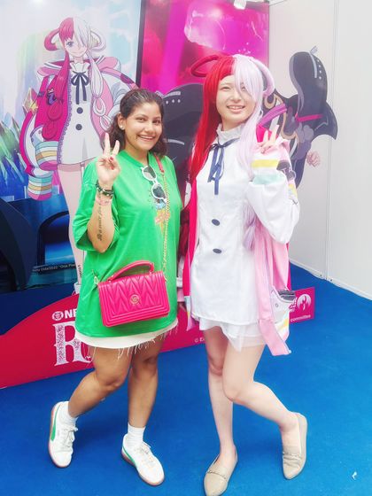 Posing with a cosplayer at the Japanese festival. This shows my interaction with the event's attractions and participants, creating engaging content that captures the spirit of the day.