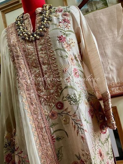 A full view of the suit, showing the coordinated kurta, lower, and the exquisite organza dupatta with tassels.