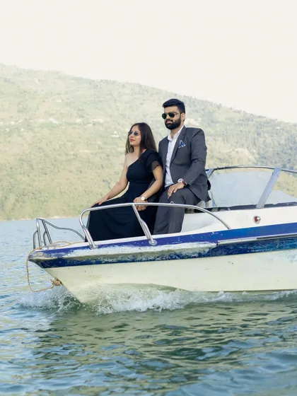An adventurous couple enjoying a speedboat ride on Tehri Lake. This shot captures the thrill and joy of starting a new life journey together, set against a stunning natural backdrop.