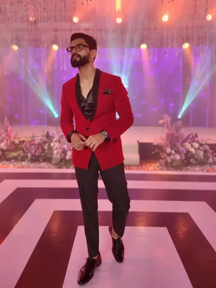 A bold red blazer for a sangeet or reception night. This look is designed to make a statement on stage.