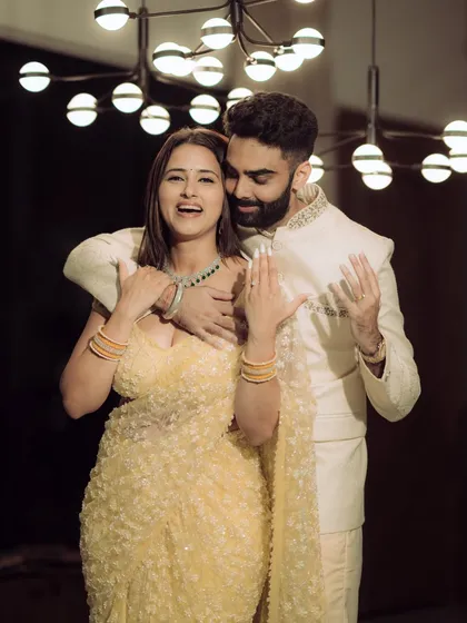 A moment of pure joy and laughter during an indoor engagement celebration. The warm lighting and genuine expressions make this a perfect blend of candid emotion and cinematic style.