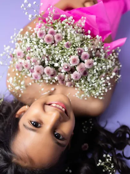 A creative and unique portrait, with this young lady blooming from a bouquet of flowers. I love thinking outside the box for our photoshoots.