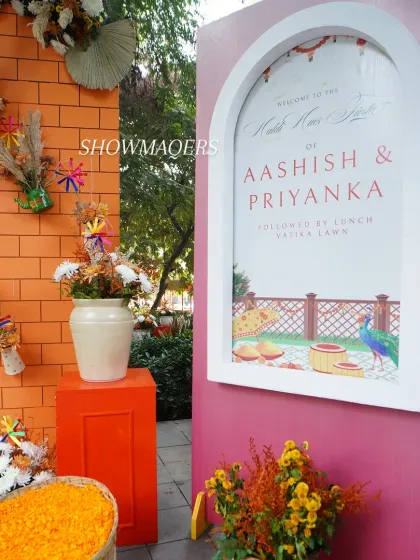 The personalized welcome signage for Ashish and Priyanka's Haldi, set against a vibrant pink wall.