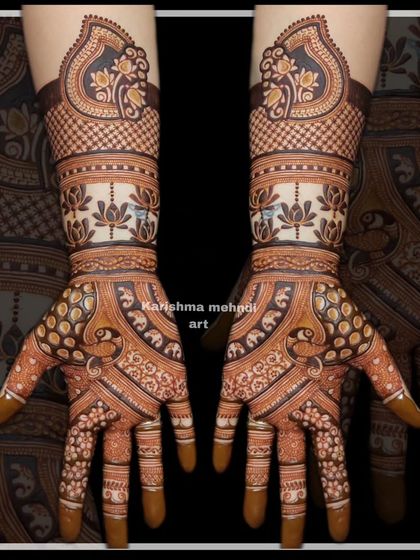 This guest mehendi features a band of lotus flowers and elephants on the palms, topped with a traditional paisley motif on the wrist.