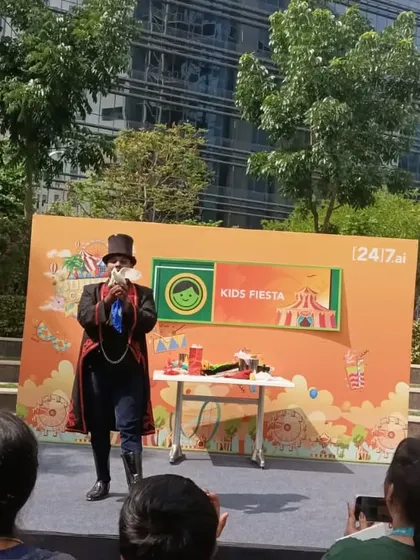 Performing on an outdoor stage for the 'Kids Fiesta' corporate family day at 24/7.ai. My show is a great entertainment choice for company events.