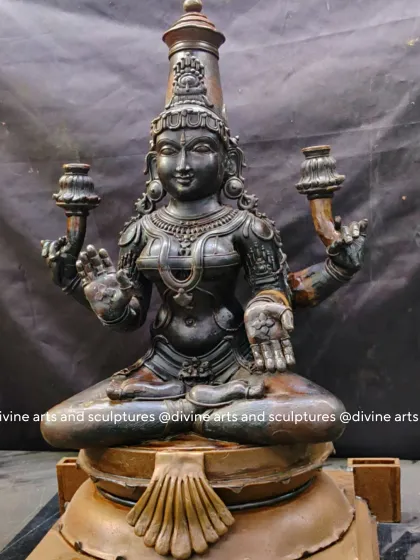 The wax stage of a Mahalakshmi idol, seated in a lotus pose. This model showcases the serene expression and the delicate details of her jewelry, all formed in wax.