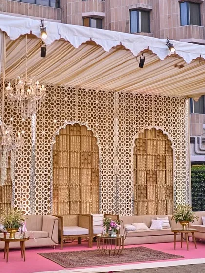 Another perspective of the elegant outdoor lounge, showing the beautiful chandeliers and soft drapes that add a touch of indoor luxury to the open-air setting.