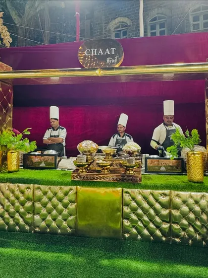 A full view of the grand chaat counter, designed to be a standout feature of the event. The quilted gold panels and plush green turf create a luxurious setting for enjoying these tangy treats.