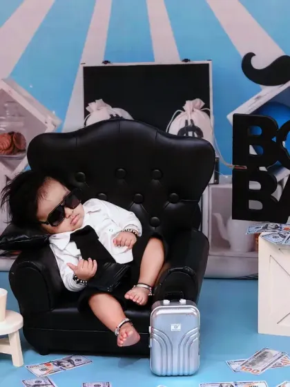 This boss baby is taking a well-deserved nap in his executive chair after a long day of meetings.