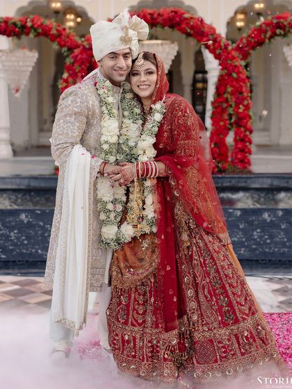A joyous portrait of Shikha and Rupen, embracing after their ceremony amidst a cloud of smoke.