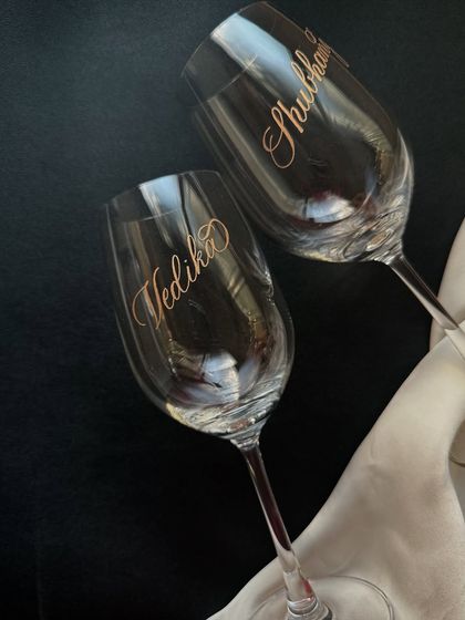 A set of wine glasses for 'Vedika' and 'Shubham', showcasing the elegant script I use for custom names. Each piece is carefully crafted by hand.