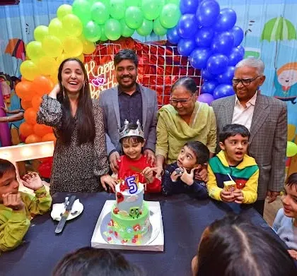 A happy family photo around the birthday cake. We provide the perfect backdrop for these cherished memories.