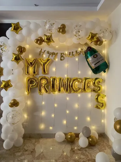 A beautiful birthday backdrop for your princess. This setup features a wall of fairy lights, a white and gold balloon arch, and "MY PRINCESS" foil letters for a truly special and personalized touch.
