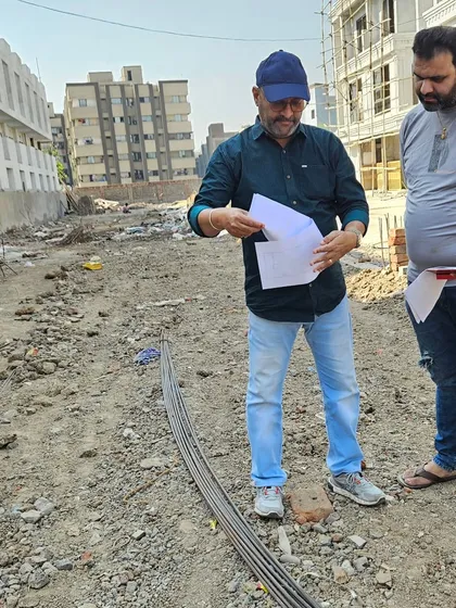 On-site at a new development, reviewing the plot layout. I check the soil, slope, and energy lines to provide a comprehensive Vastu report before construction begins.