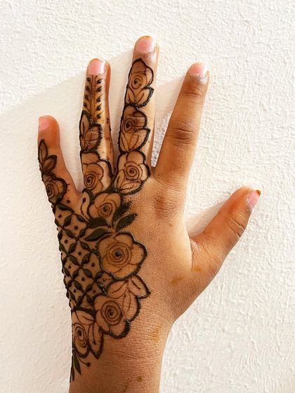 A beautiful floral design covering the back of a child's hand.